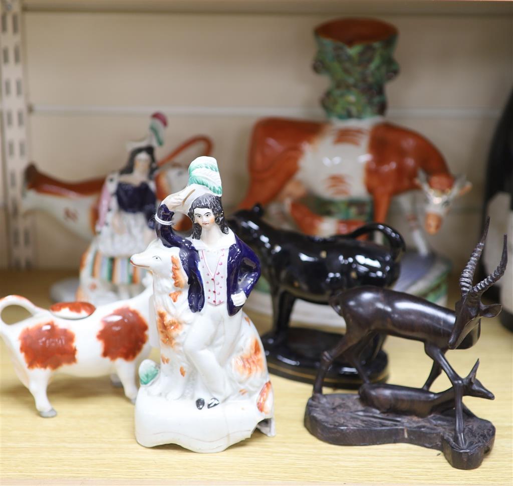 Three Staffordshire cow creamers, a similar cow group and a pair of spaniel groups
